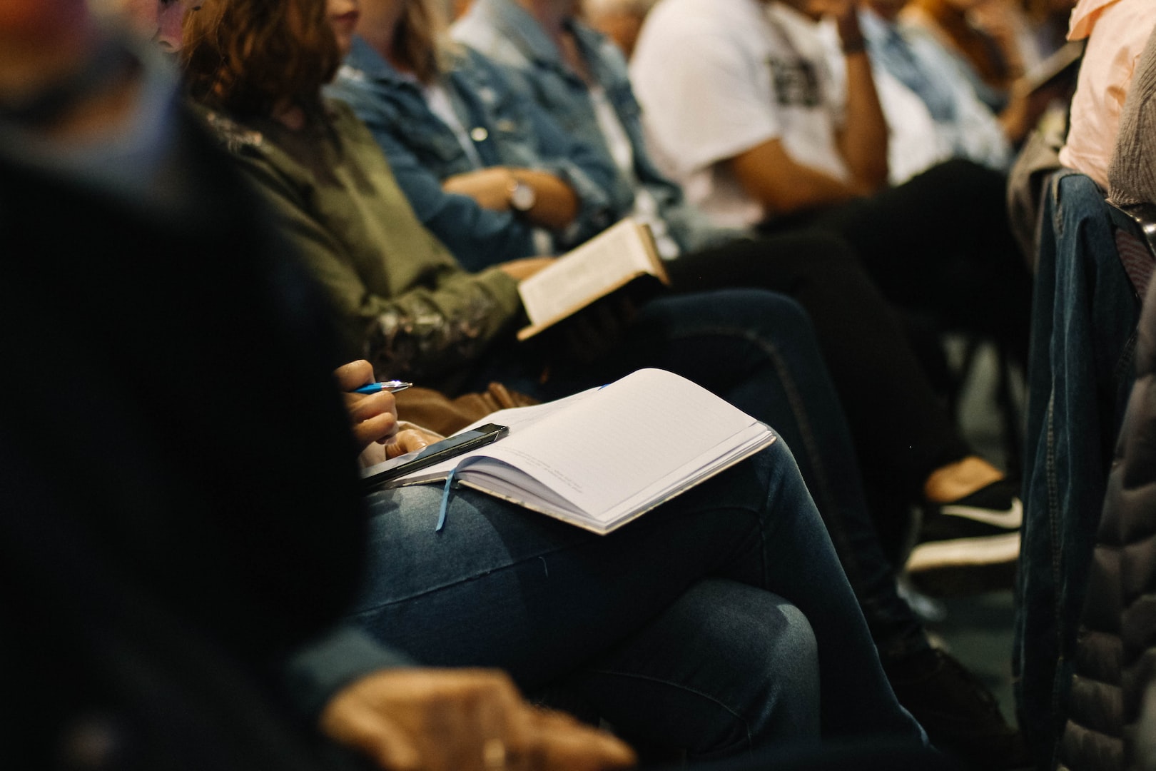 photo of seated guests holding open bibles in their laps
